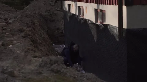 Worker Inspecting Basement Foundation Waterproofing and Outdoor Insulation Stock Footage 337701819