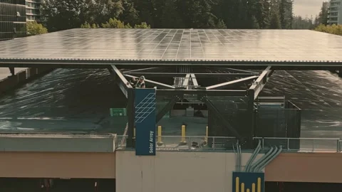 Worker inspecting expansive solar array steel framework filmed by smooth Stock-Footage 333964605