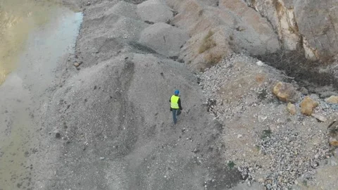Worker inspecting stones in surface stone quarry Stock Footage 266723228