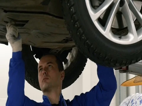 The worker inspects the bottom of the car with a lantern. The worker is removed Stock Footage 80508102