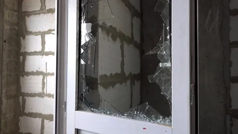 Worker inspects broken glass, vandals broke glass Stock Footage 115438719