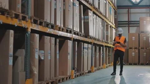 The worker inspects the goods in the warehouse. Warehouse manager enters data Видео 297372592