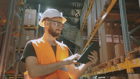 The worker inspects the goods in the warehouse. Warehouse manager enters data Видео 308160661