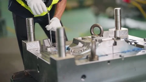 Worker inspects metal mold with care Stock Footage 341925672