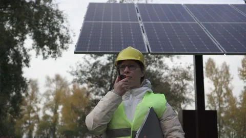 Worker inspects the solar panels and reports the information to the management Stock Footage 144357634