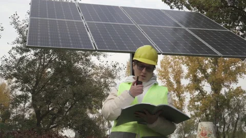 Worker inspects the solar panels and reports the information to the management Stock Footage 144357901