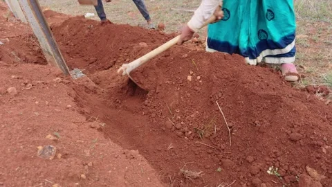 Worker Install Boundary Mesh with Pickaxe on Clay Terrain Stock Footage 311628196