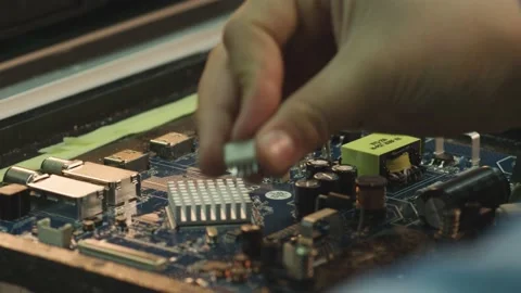 Worker install elements on an electronic circuit board at a TV factory Stock Footage 162364579