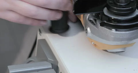 Worker install the handle of an angle grinder Stock Footage 129967286