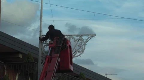 Worker install illumination, with sound of bell tower Stock Footage 8829361