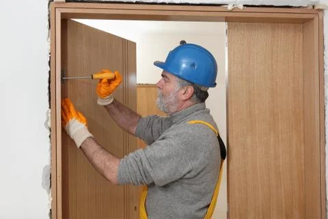 Worker install new door Stock Photos