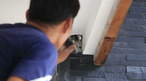 Worker install stone wall surface with cement for house  Stock Footage 39567520