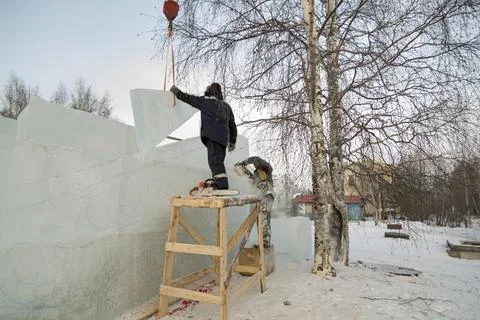 Worker on the installation of an ice panel 스톡 사진