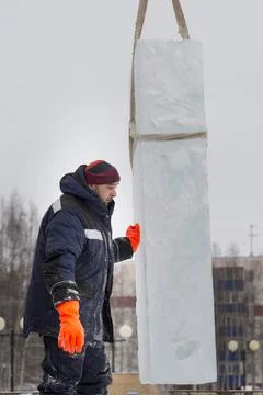 Worker on the installation of an ice panel 스톡 사진