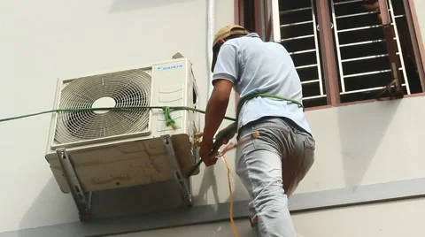 Worker is installing air conditioners in the house Stock Footage