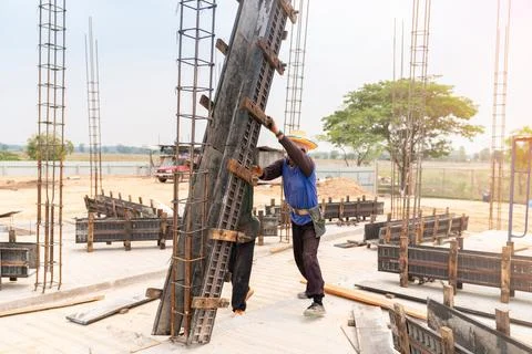 Worker is installing and assembling column formworks. Stock Photos