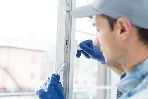The worker installing and checking window in the house Foto stock