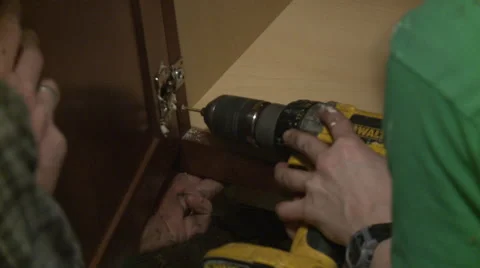 Worker installing cabinet Stock Footage 57674511