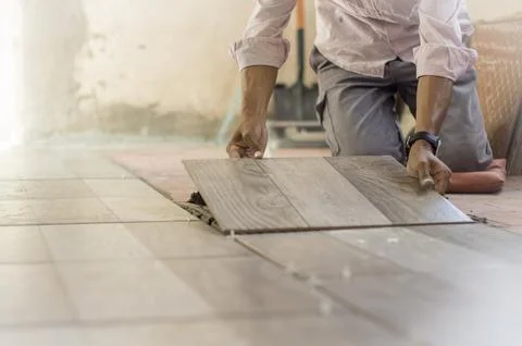 Worker installing a ceramic floor Stock Photos