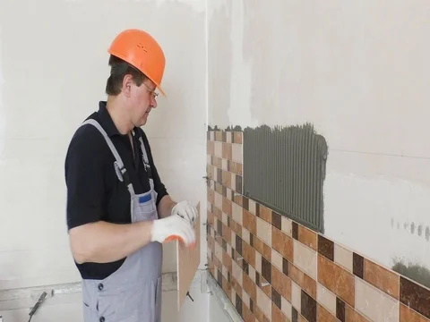The worker is installing the ceramic tile. Stock Footage 79249719