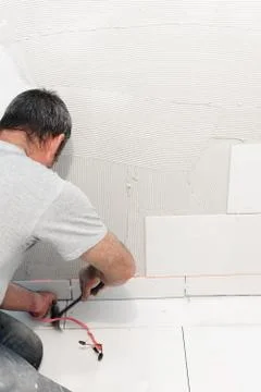 Worker installing ceramic tiles Stock Photos