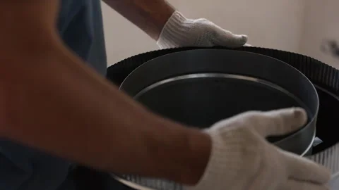 Worker installing circular ventilation fan inside metal duct Stock Footage 342613516