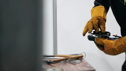 Worker installing cutting disc on angle grinder in workshop. Stock Footage 347780597