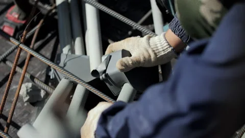 Worker installing electrical conduit box at construction site Stock Footage 317562293