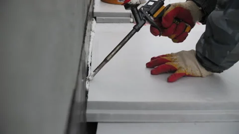 Worker Installing Foam Insulation Panels with Sealant Stock Footage 303783857