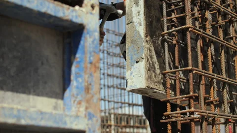 Worker installing formwork panel around steel reinforcement Stock Footage 314644726