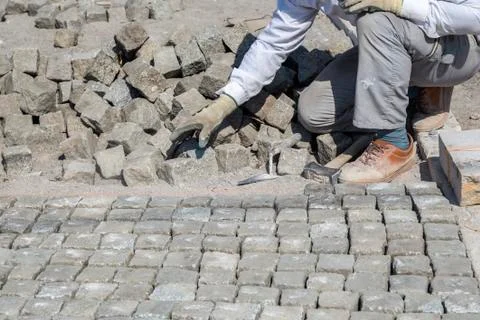 Worker installing granite cubes Stock Photos