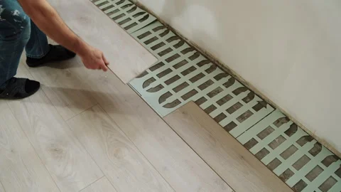 Worker Installing Laminate Flooring on Foam Underlayment Stock Footage 322054898