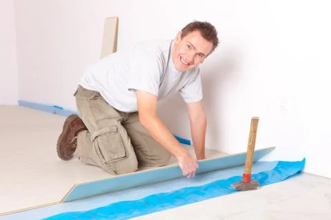 Worker installing a laminated flooring Stock Photos