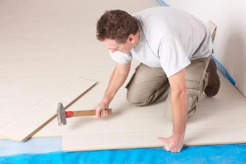 Worker installing a laminated flooring Stock Photos