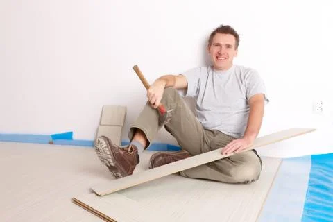 Worker installing a laminated flooring Stock Photos