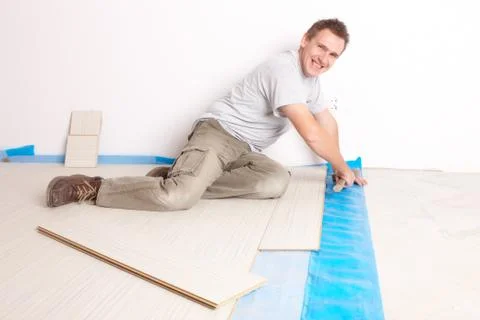 Worker installing a laminated flooring Stock Photos