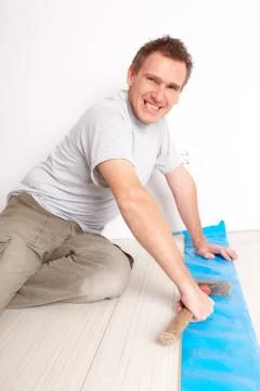 Worker installing a laminated flooring Stock Photos