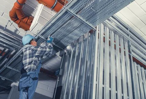 Worker Installing Metal Framework in a Modern Building Under Construction Fotos de archivo