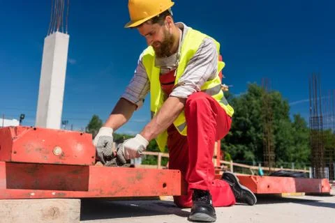 Worker installing metallic framing Stock Photos