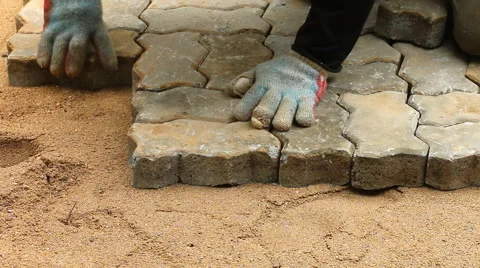 Worker installing old cobblestone block for build floor ground Stock Footage 42620801