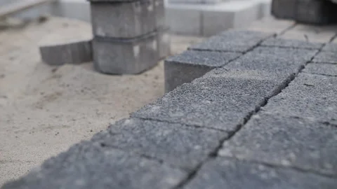 Worker Installing Pavement Blocks by Hand Stock Footage 313757803