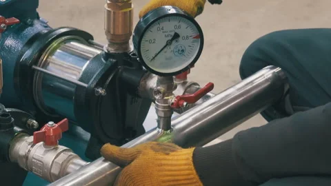 Worker Installing Pressure Gauge on Water Pump System | Technician Assembling Stock Footage 344358010