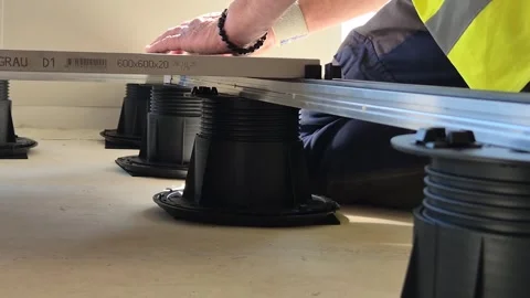 Worker Installing Raised Floor Tile on Pedestals in Budapest Stock Footage 333043171