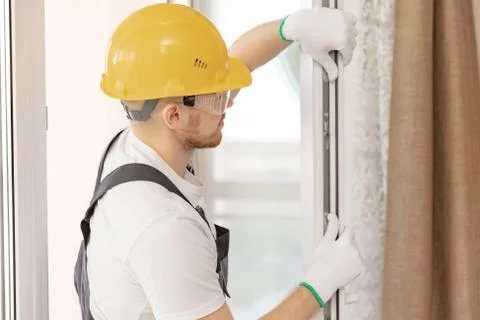 Worker in installing rubber seals on plastic upvc window Stock Photos