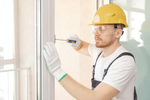 Worker in installing rubber seals on plastic upvc window 스톡 사진