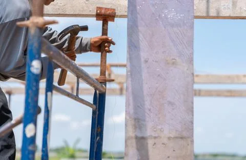 Worker Installing Scaffolding Elements for second floor Stock Photos