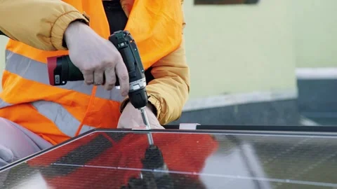 Worker installing solar panels on rooftop. Stock Footage 330942664