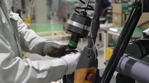 Worker installing suspension spring and motor assembly onto washing machine Video stock 334965291