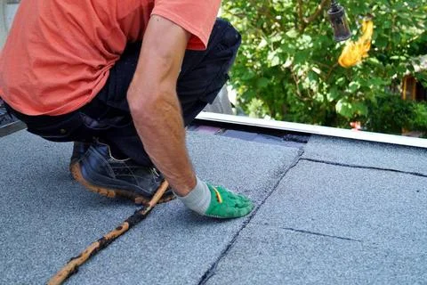 Worker installing tar foil on the rooftop of building. Flat roof installat... Fotos de archivo