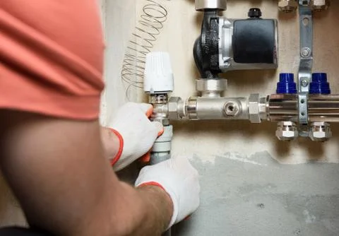 A worker is installing a thermal head. Stock Photos